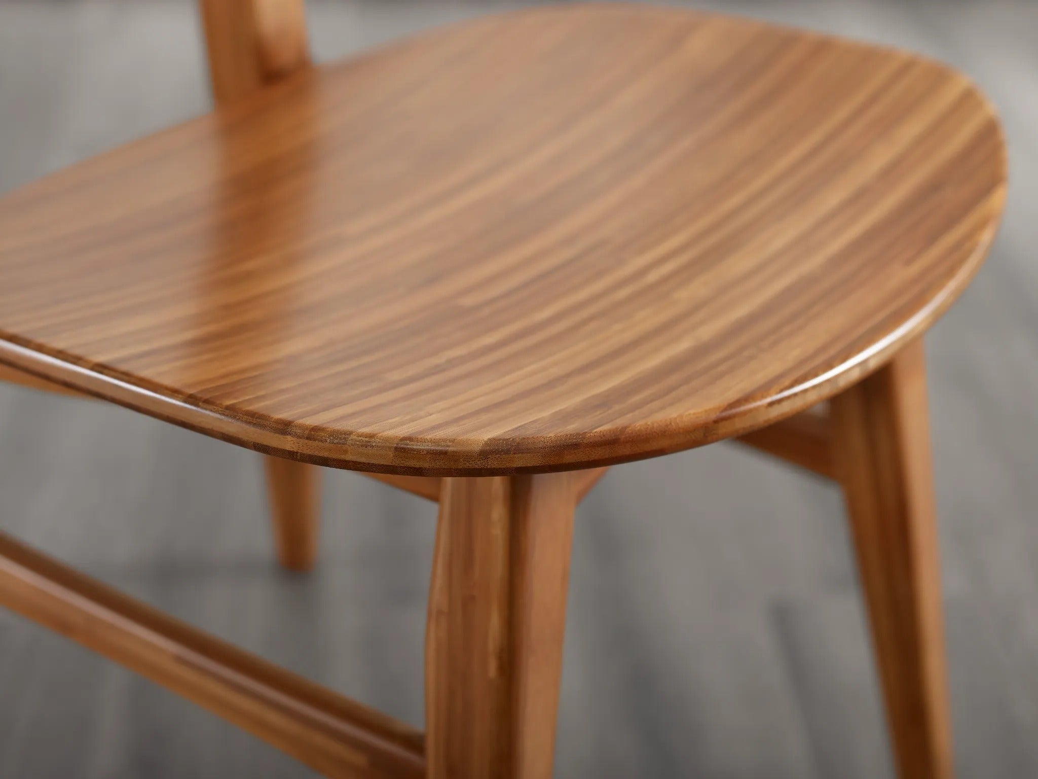 A renewable Cassia Bamboo Dining Chair by Greenington in amber color, detailed view of the seat surface.